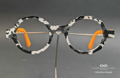 Monture artisanale ronde décagonale moucheté noir blanc branche orange en acétate